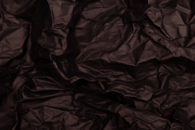 Texture ou fond de papier froissé aux tons noirs détaillés