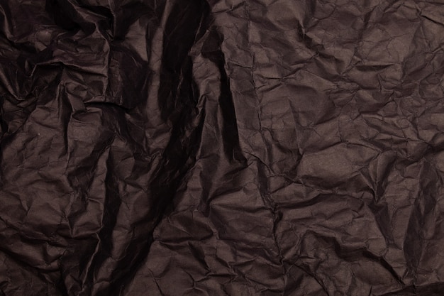 Texture ou fond de papier froissé aux tons noirs détaillés