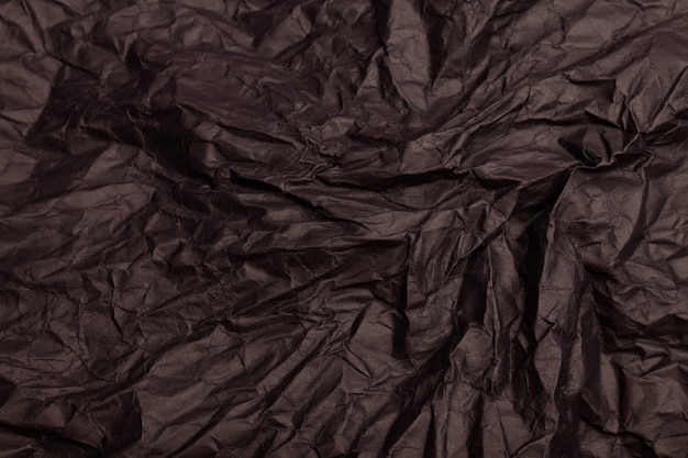 Texture ou fond de papier froissé aux tons noirs détaillés