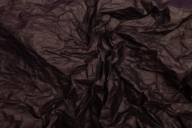 Texture ou fond de papier froissé aux tons noirs détaillés