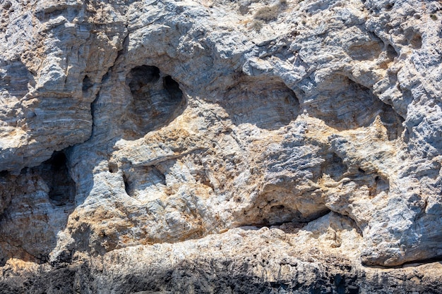 Texture de fond de roche grise Formation de pierre matériau naturel rugueux façonné par le vent de sel de mer