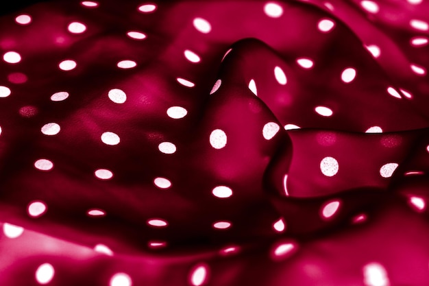 Texture de fond textile à pois classique points blancs sur le motif de conception de tissu de luxe rouge