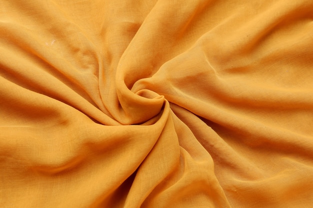 Texture de fond de tissu de couleur jaune safran sans couture avec un beau tissu de détail de gros plan.