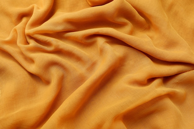 Texture de fond de tissu de couleur jaune safran sans couture avec un beau tissu de détail de gros plan.