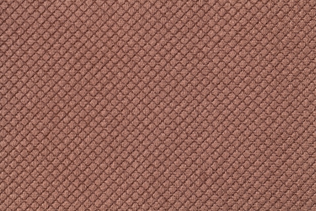 Texture de fond de tissu moelleux marron foncé avec motif rhomboïde, macro.