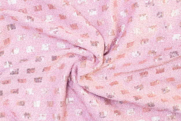 Texture de fond de tissu rose doux tricoté avec des paillettes. beau fond