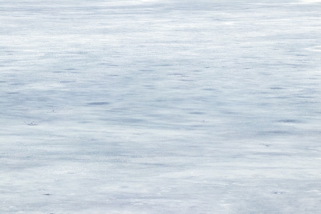 Texture de glace couverte de neige, fond d'hiver