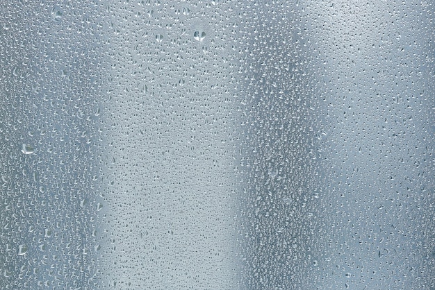 Photo texture d'une goutte de pluie sur un fond transparent verre humide