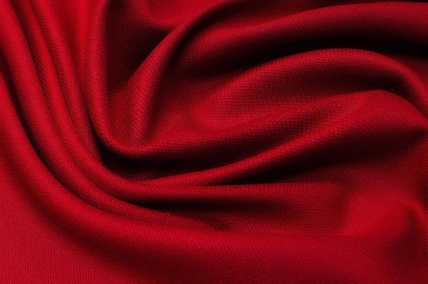 Texture en gros plan d'un tissu ou d'un tissu rouge ou fuchsia naturel de la même couleur