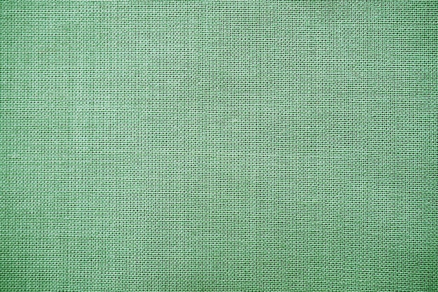 Texture de gros plan de tissu vert naturel La texture du tissu est faite de matière textile naturelle en coton ou en lin Fond de toile verte Tissu lissé à surface lisse