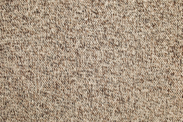 Texture laine tricotée surface marron beige blanc. Fond, papier peint à partir de fibres. Tissu chaud. Photo de haute qualité