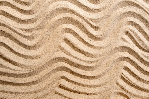 Texture ligne sable sur la plage, fond de surface nature