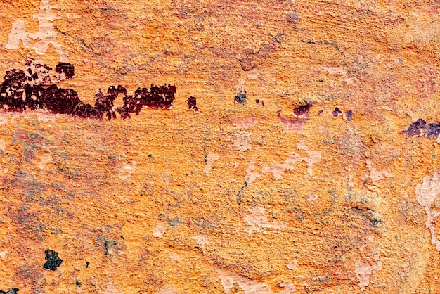 Texture d'un mur de béton avec des fissures et des rayures qui peuvent être utilisées comme arrière-plan