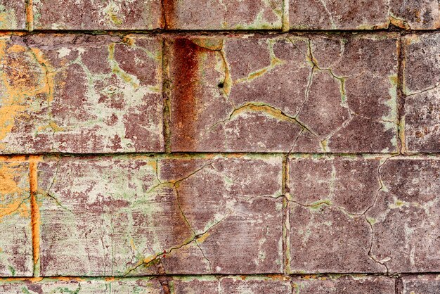 Texture d'un mur en béton avec fissures et rayures