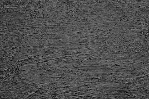 Texture d'un mur de béton avec des fissures et des rayures