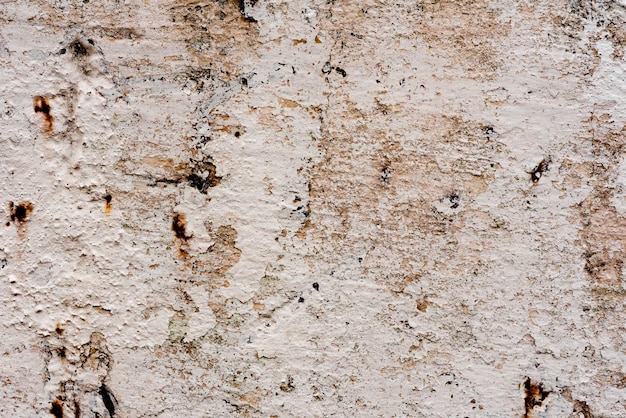 Texture d'un mur de béton avec des fissures et des rayures