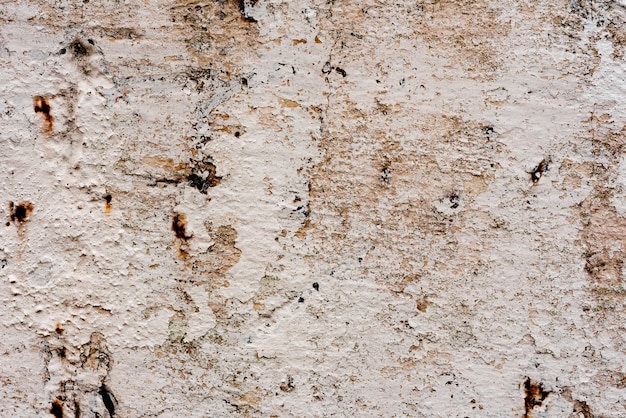 Texture d&#39;un mur de béton avec des fissures et des rayures