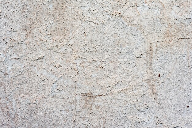 Texture d&#39;un mur de béton avec des fissures et des rayures