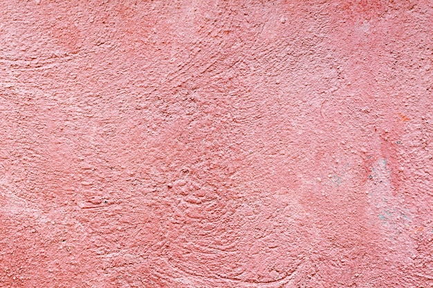 Texture de mur de béton peint rose