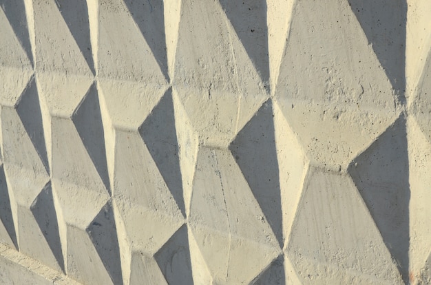 Texture d&#39;un mur de béton en relief de couleur beige