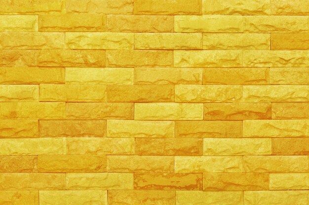 Photo texture de mur de brique jaune doré avec motif de style vintage pour les œuvres d'art de fond et de conception