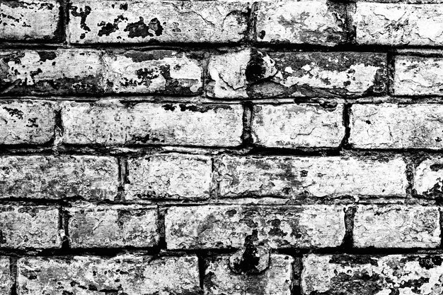 Texture d'un mur de briques avec des fissures et des rayures qui peuvent être utilisées comme arrière-plan