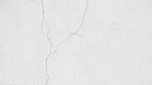 Texture de mur de ciment blanc fissure