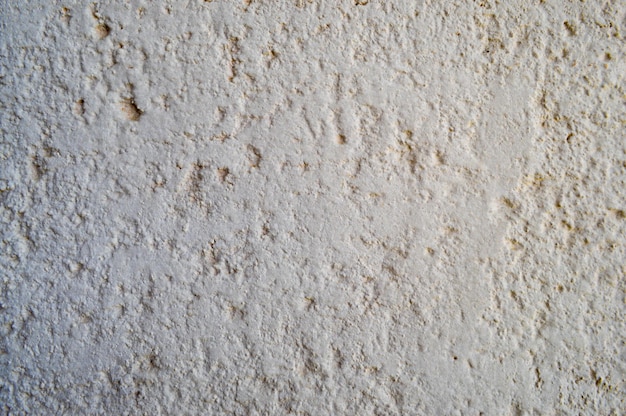 Texture de mur gris ciment béton jaune rond rugueux avec du plâtre avec des irrégularités anciennes anciennes