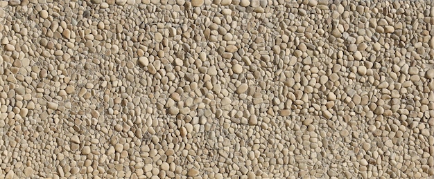 Texture d'un mur de pierre avec de petits cailloux ronds Partie d'un mur de pierre comme arrière-plan ou texture