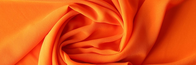 Texture orange de fond de tissu de coton ou de tissu synthétique