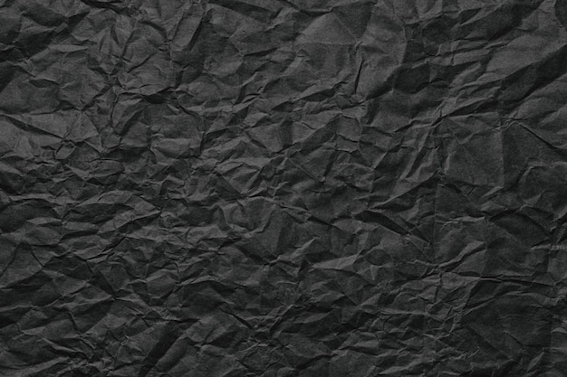 Texture de page rugueuse de fond de papier froissé noir