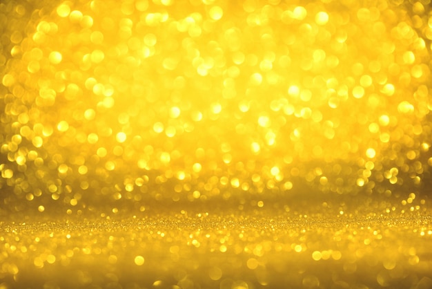 Photo texture de paillettes d'or coloré abstrait flou pour anniversaire du nouvel an ou noël