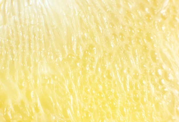 Texture de pamplemousse à l'intérieur sur le fond blanc. Citrus en gros plan photo. Photo de mode de vie sain. Beau fond d'écran. Concept végétarien et végétalien. Vitamines de la nature.