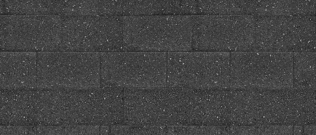 Texture panoramique large de bloc de granit noir. Fond de mur de brique de grande tuile de pierre gris foncé