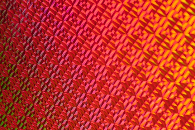 Texture de papier d'aluminium coloré avec effet holographique. Noël, nouvel an, vacances, festival, fond de carnaval