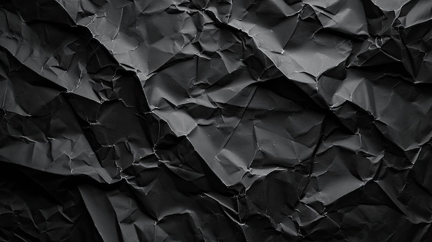 Texture de papier froissé noir sur fond faible lumière