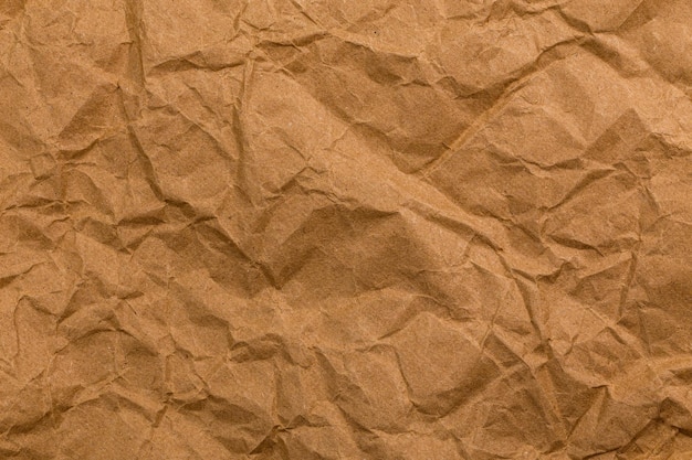 Texture de papier kraft brun froissé en lambeaux et fond plein cadre