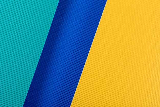 Texture de papier ondulé jaune et bleu Formes et lignes géométriques Fond minimaliste Espace de copie plat
