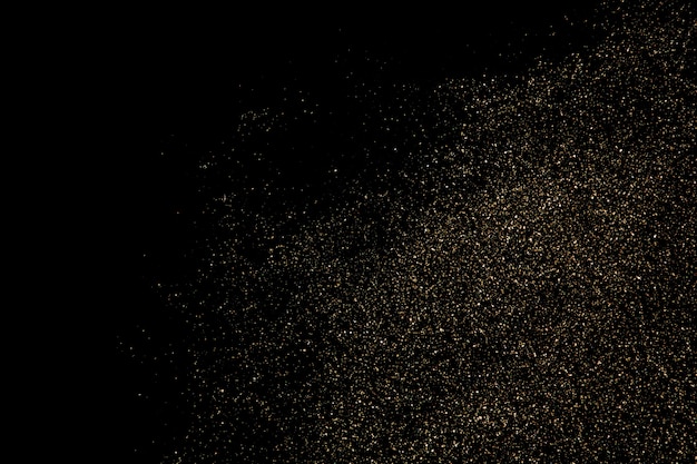 Texture de particules de paillettes d'or isolé sur fond noir