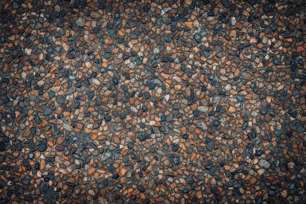 Texture de petites pierres multicolores Fond d'asphalte