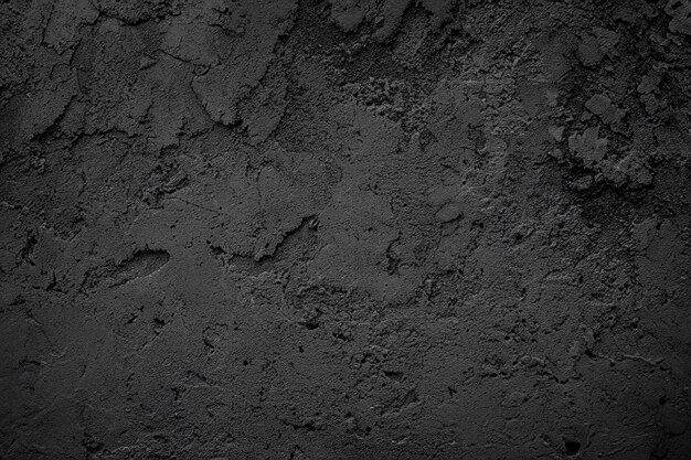 Texture de pierre brute ou de plâtre de sable noir ou gris foncé