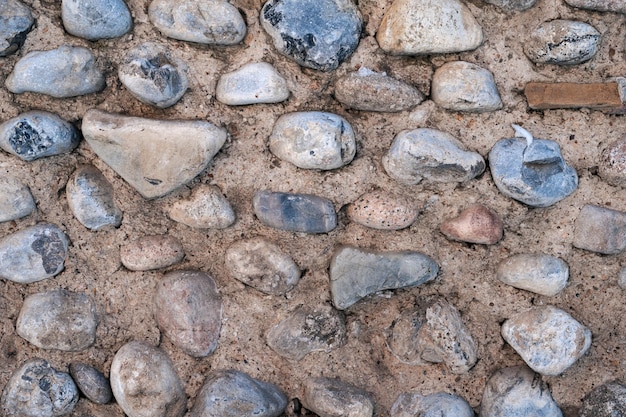 Texture de pierres pavées dans un mur de béton