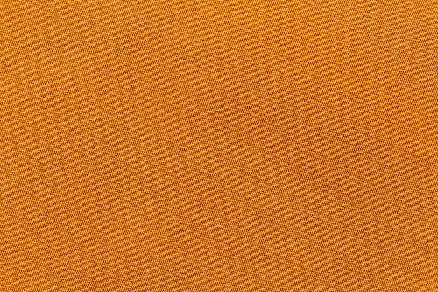 Texture de polyester de tissu de tissu de couleur orange et fond textile