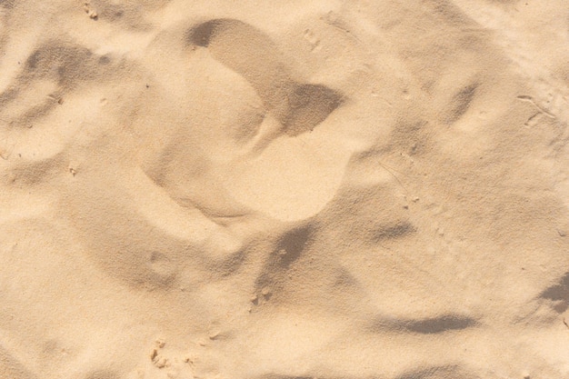 Texture de sable de plage tropicale au coucher du soleil