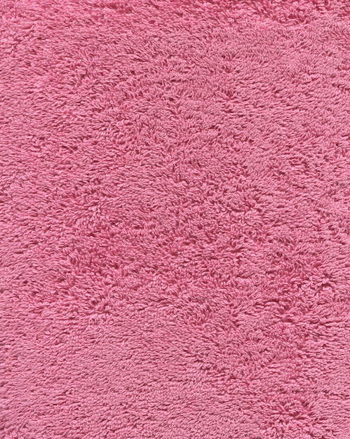 Texture de serviette de bain de couleur rose. Fond de serviette de bain en tissu rose.