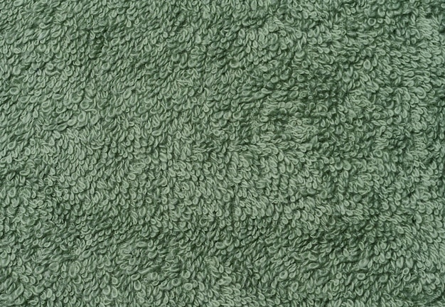 Texture d'une serviette en coton vert en terry sur une toile Macro