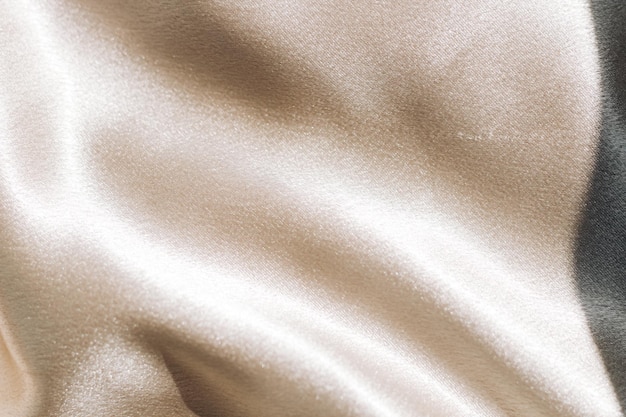 Photo texture de soie lisse dorée de soie de beauté