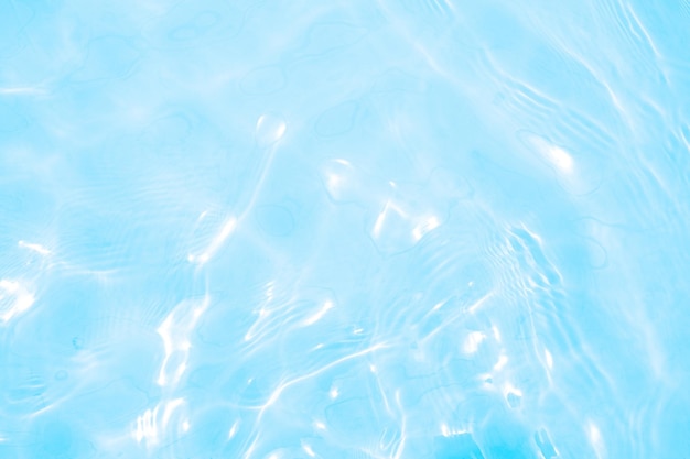Texture de surface de l'eau calme claire de couleur bleue transparente floue avec des éclaboussures et des bulles Fond de nature abstraite à la mode Vagues d'eau au fond de l'eau du soleil