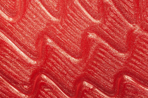 Texture tachée de rouge à lèvres brillant