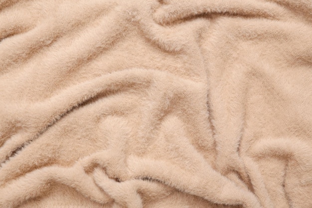 Texture de tissu beige doux du pull en gros plan